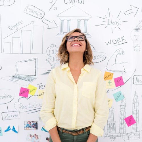 Creative business woman thinking and brainstorming with a wall chart at the background